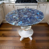 Elegant Round Labradorite Gemstone Table with White Pedestal Base in Modern Kitchen